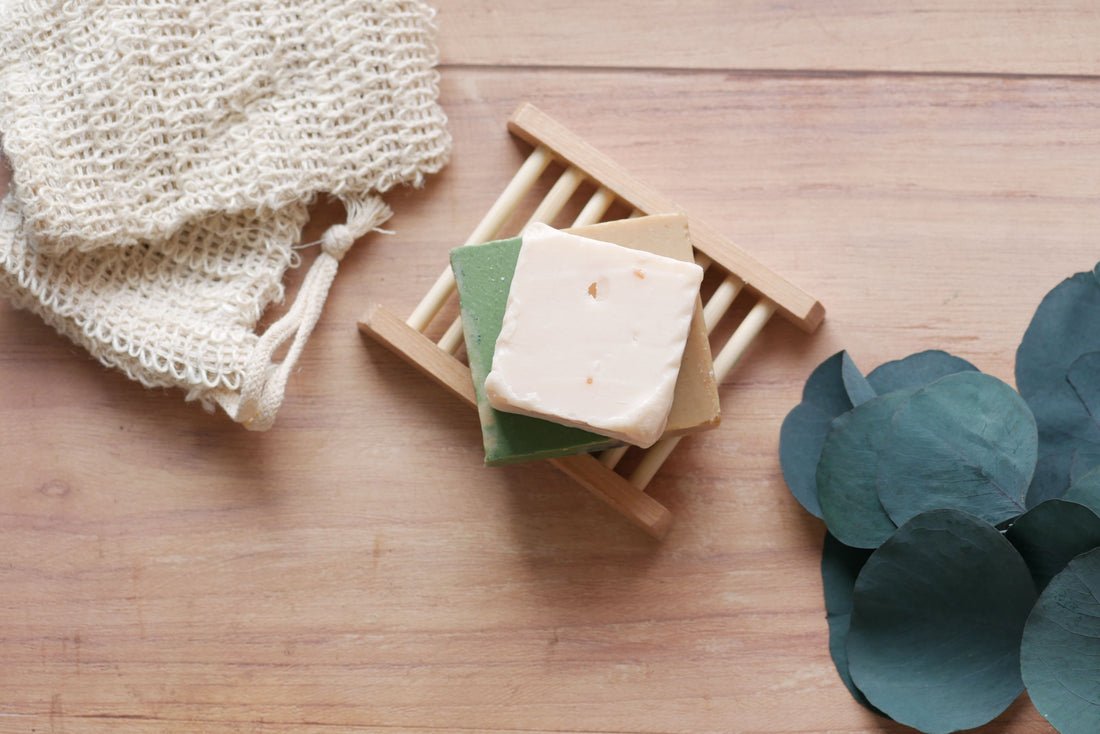 Soft spring self-care flatlay with natural skincare products on a light linen surface — NINÜ