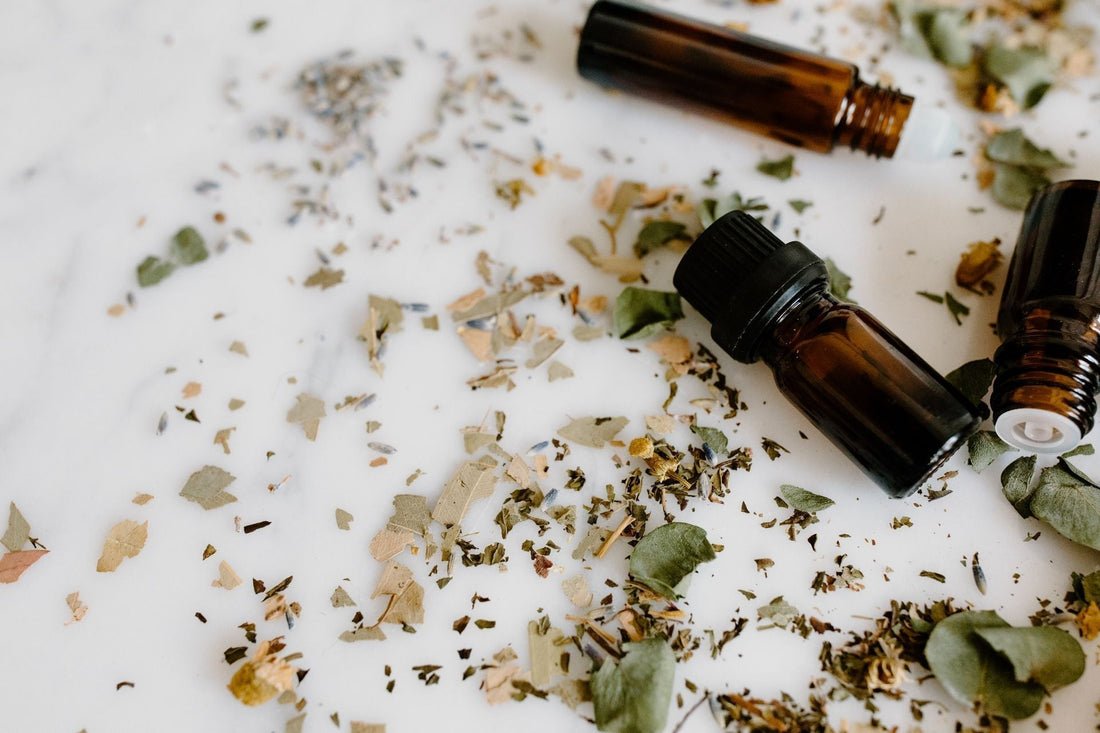 Aromatherapist's selection of essential oils for sleep on a warm neutral surface